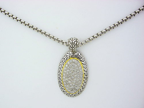 Vintage sterling silver oval pendant necklace featuring a brilliant gemstone surrounded by a halo of cubic zirconia